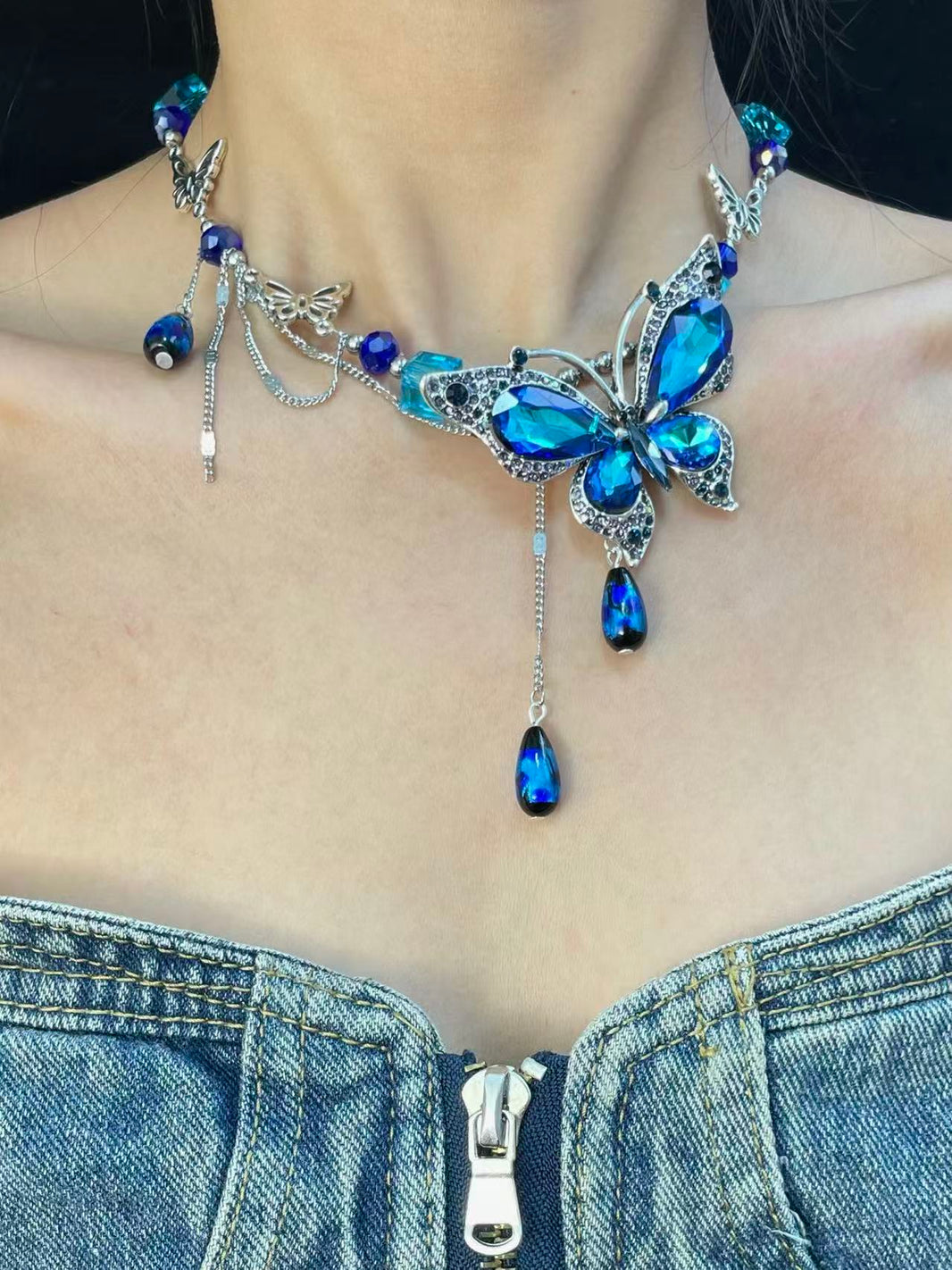 Close-up of royal blue crystal butterfly pendant with ocean blue teardrop beads