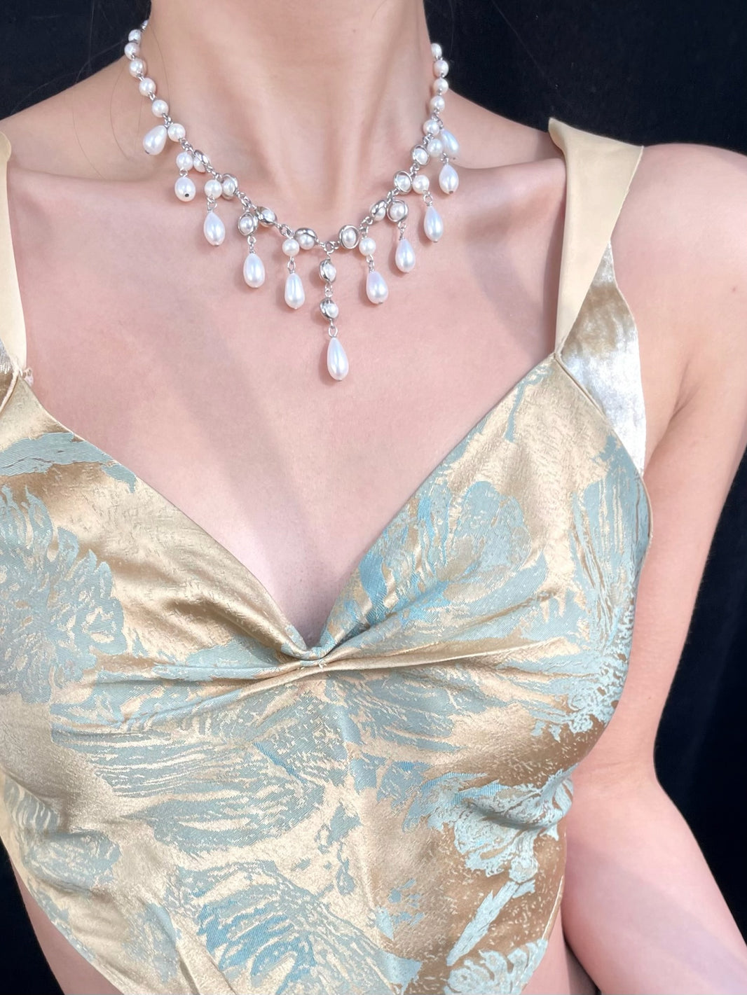 Close-up of cascading teardrop pearl drops with silver link accents