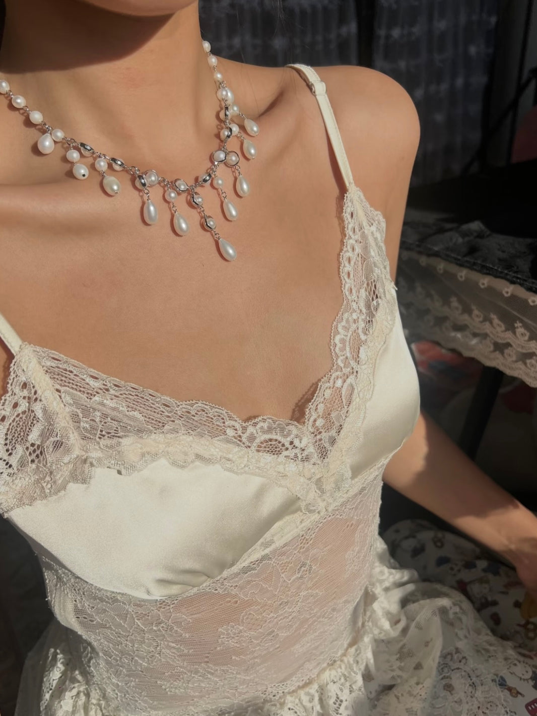 Classic baroque teardrop pearl cascade choker styled on a bridal lace corset