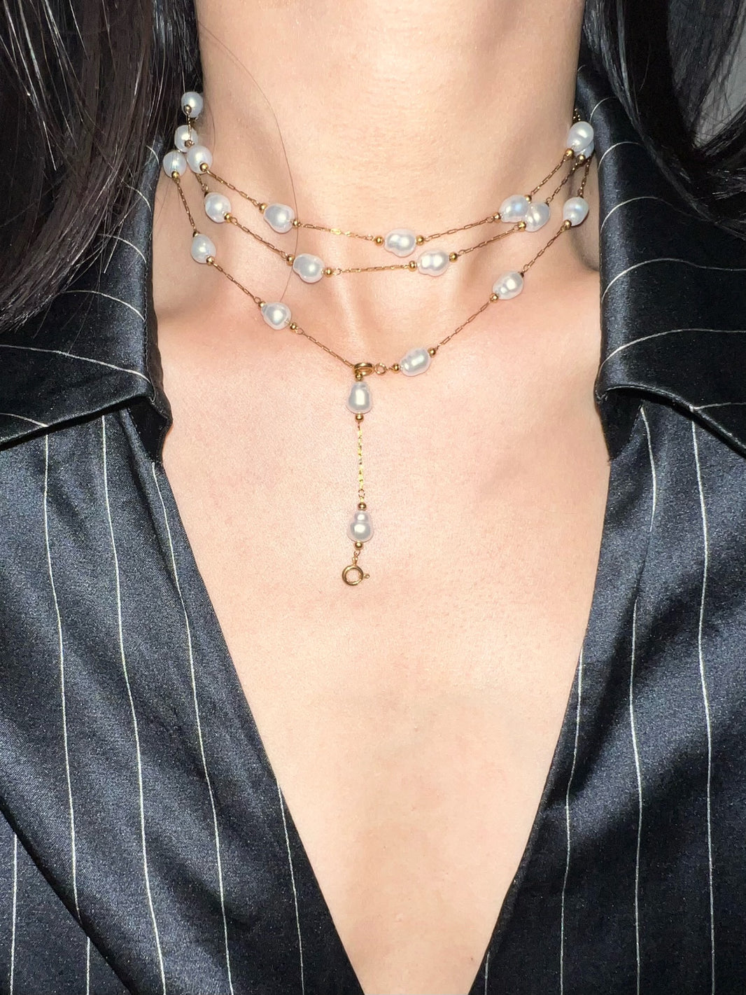 3-way gold baroque freshwater pearl choker styled as 3-layer necklace on black satin shirt